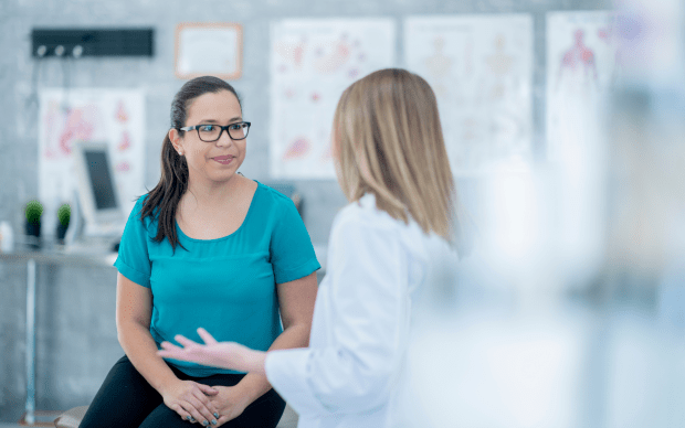 a woman meets with her doctor